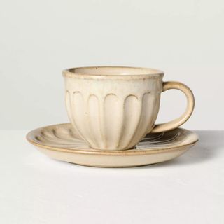 A cream espresso cup with grooves