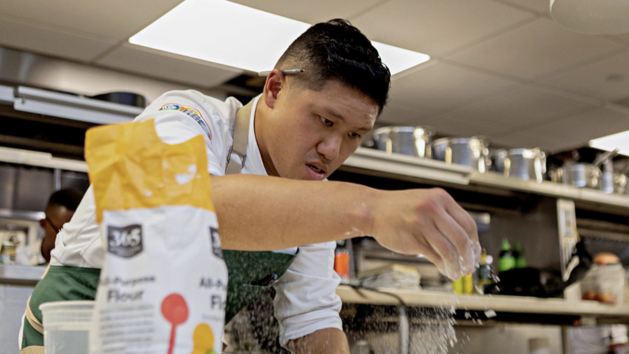 Laurence adding flour to a dish in Top Chef Season 23 Finale