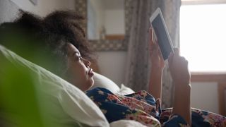Frozen Kindle - woman holding kindle in bed