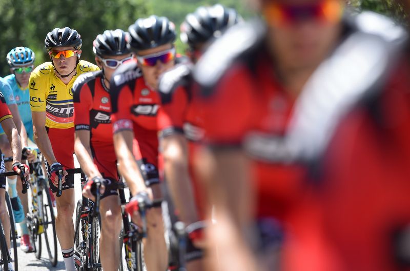 The BMC train looks after Rohan Dennis in yellow