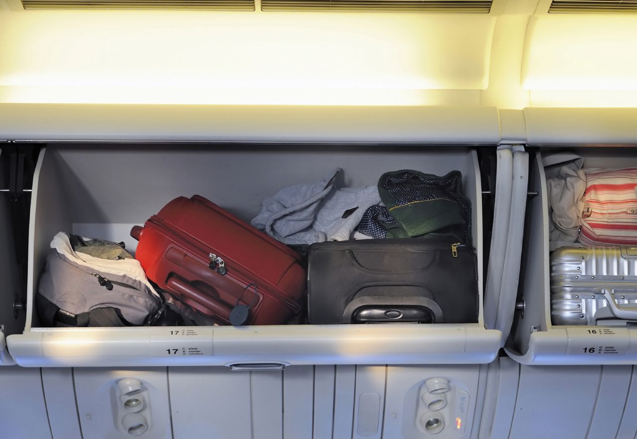 A man is forced to show the contents of his luggage.