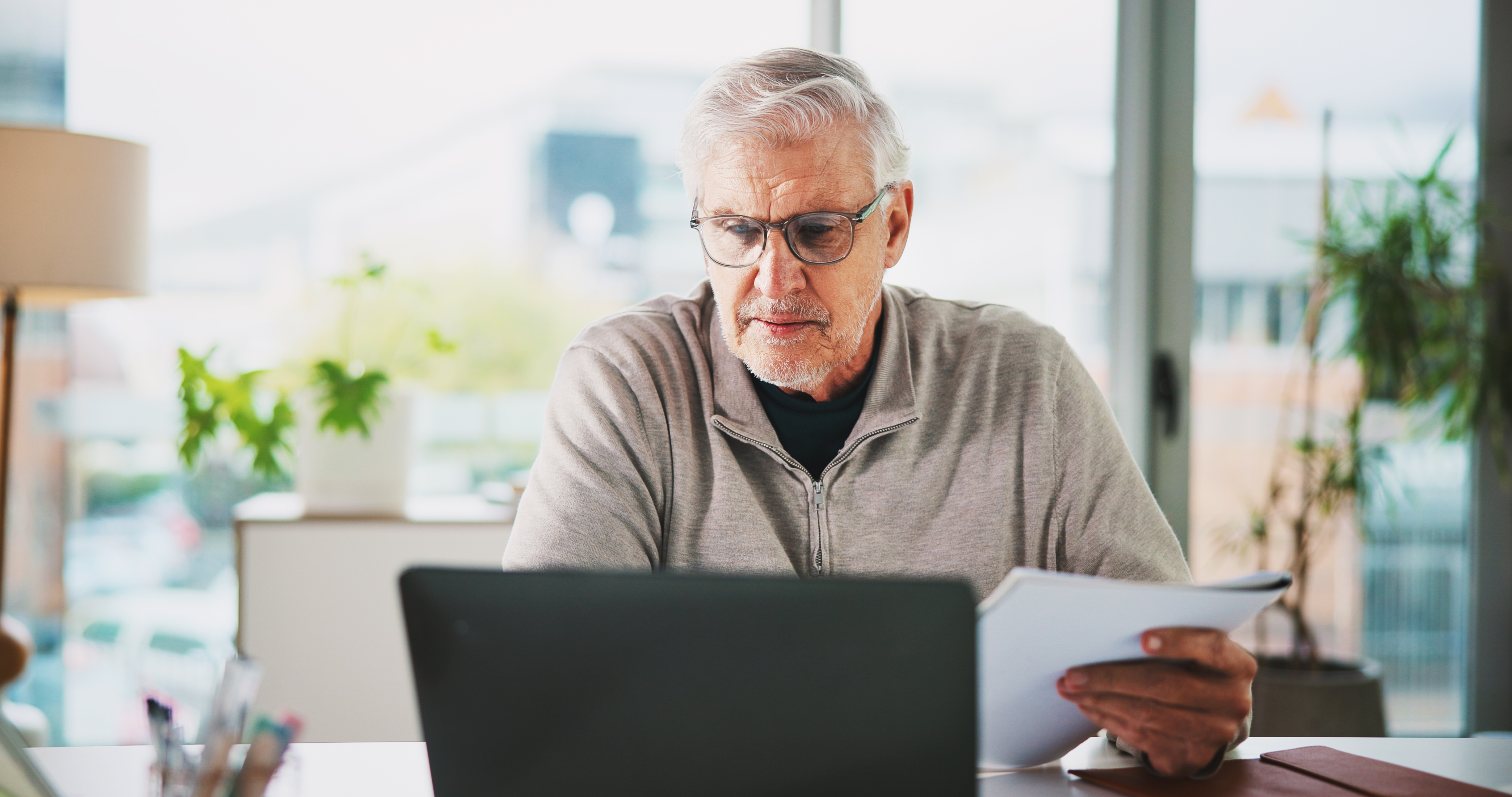 Pensioner looking at personal finances on computer