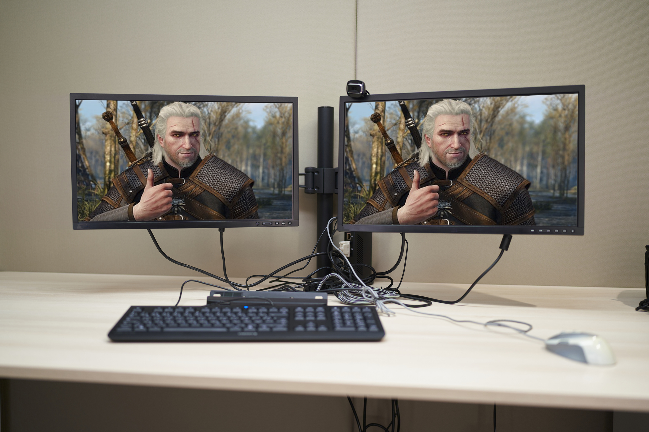 Modern workspace computer with two monitor black screen in desk home interior - stock photo, photoshopped so both monitors display geralt of rivia holding a thumbs up