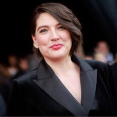 author taylor jenkins reid wearing a black tux suit on the red carpet 