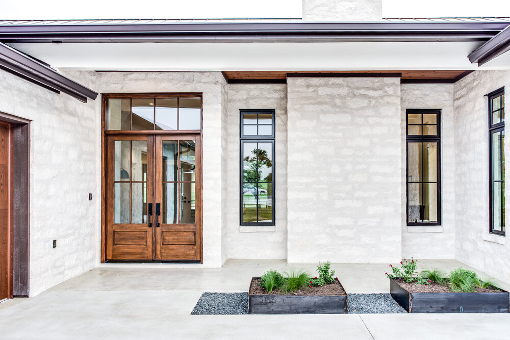 Part glazed front door on house with stone facade