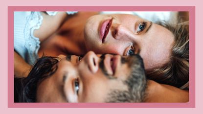 What is a delusionship'? Pictured: Girlfriend and boyfriend looking up while lying on bed at home 