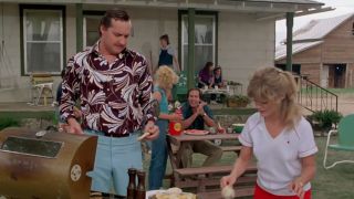 Randy Quaid in a colorful shirt talking to Beverly D'Angela in Vacation