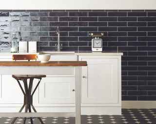 bathroom with dark coloured tiles for a monochrome scheme and white counters