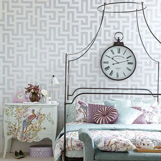 bedroom with wall clock and side table