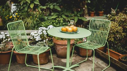 Green patio furniture in a garden