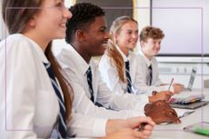 Four kids in school uniform smiling