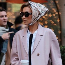 Bella Hadid was spotted in New York wearing a winter take on the capri trend, a pale pink coat, and a silk hair scarf