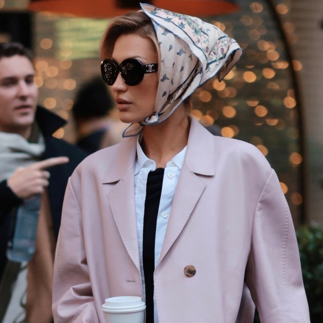 Bella Hadid was spotted in New York wearing a winter take on the capri trend, a pale pink coat, and a silk hair scarf