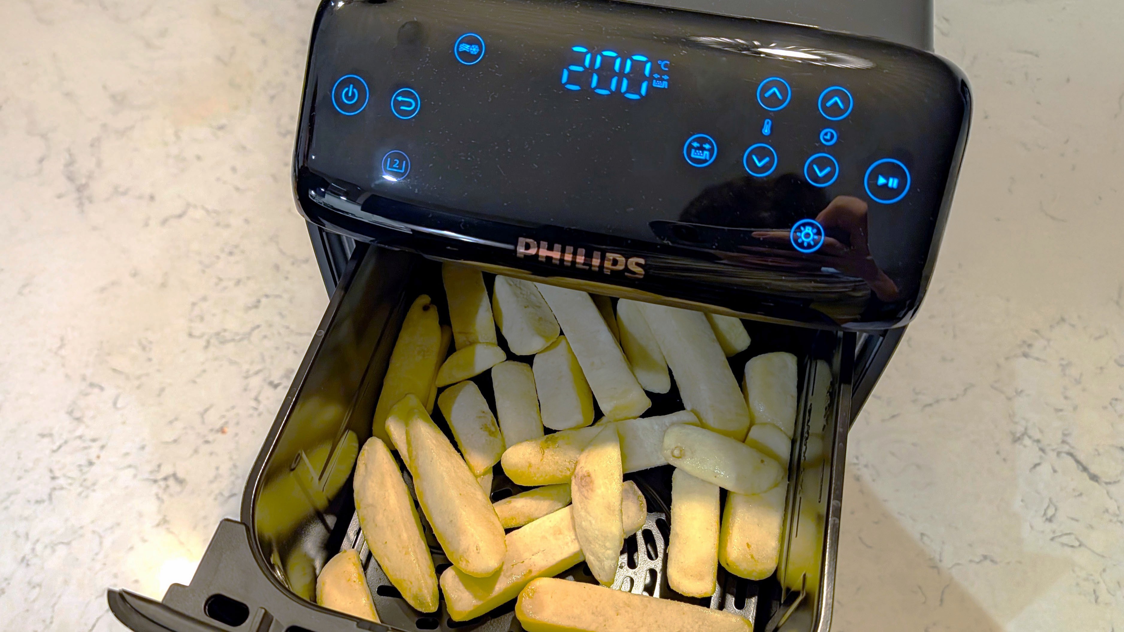 Uncooked fries inside Philips 4000 Series Airfryer