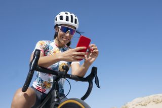 woman looking at phone in cycling kit