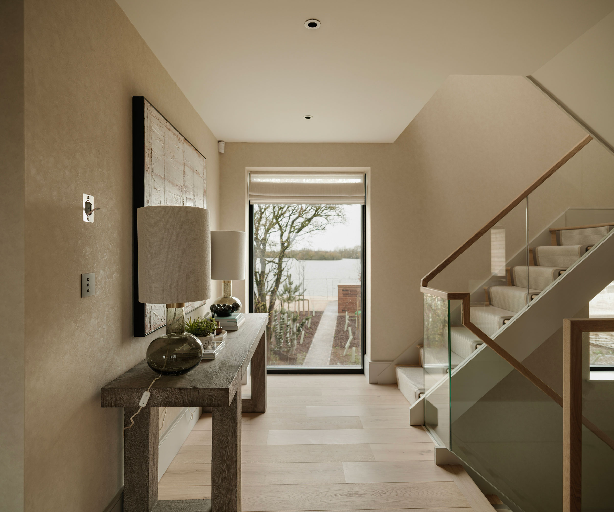 modern landing with picture window and wide plank wooden flooring
