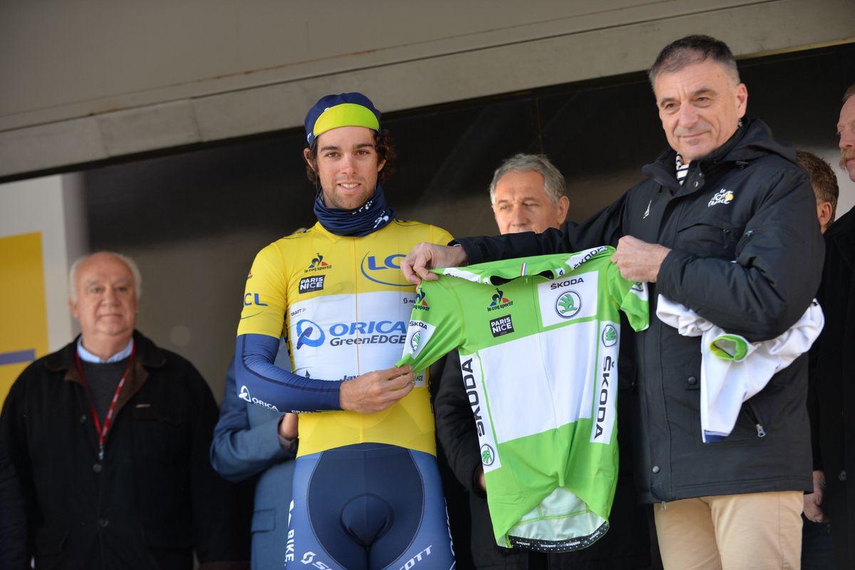 Michael Matthews is presented with the green jersey on stage while wearing the yellow jersey