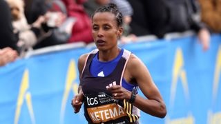 Tigist Ketema runs in a black vest and blue undershirt at the Berlin Marathon.