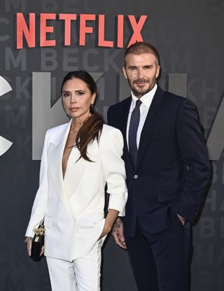 Victoria Beckham poses with her husband, David Beckham.
