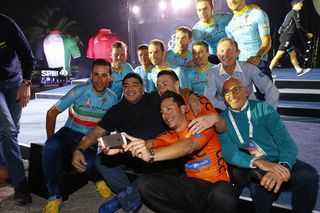 Riders pile in to pose with Diego Maradona