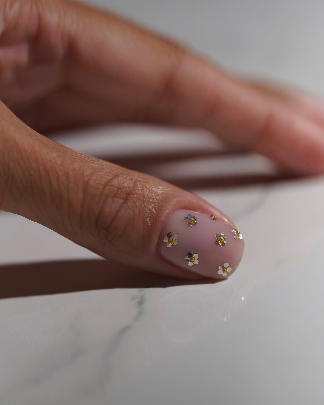 A mixed metal floral manicure by Iram Shelton