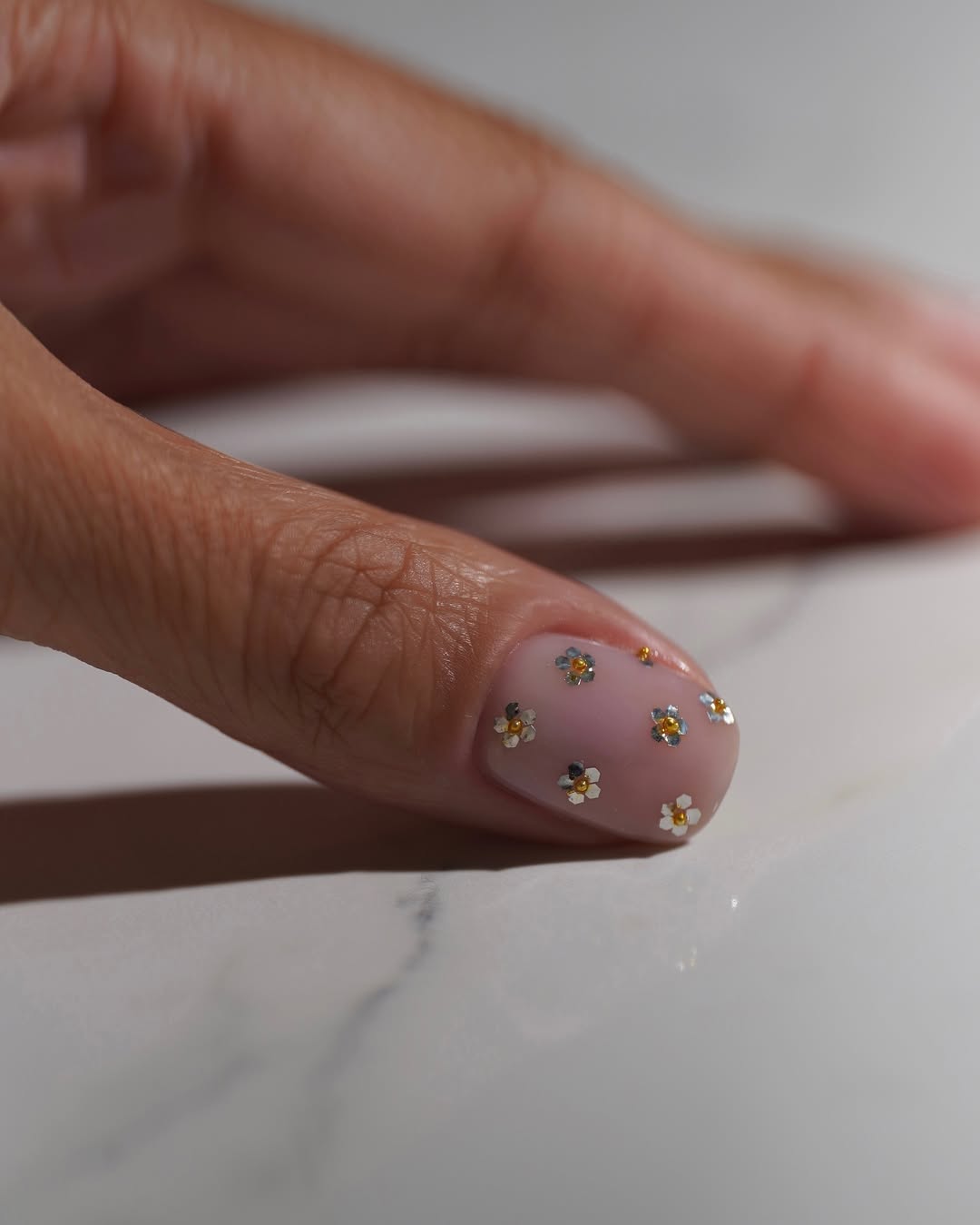 A mixed metal floral manicure by Iram Shelton
