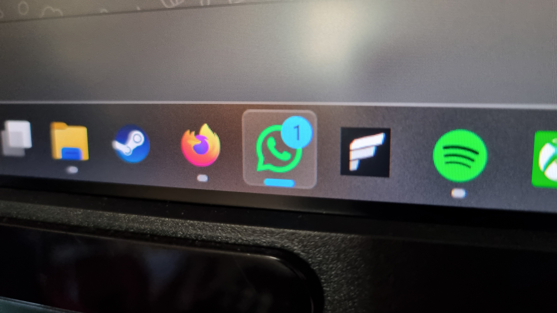 A photo of the WhatsApp logo displayed on a screen