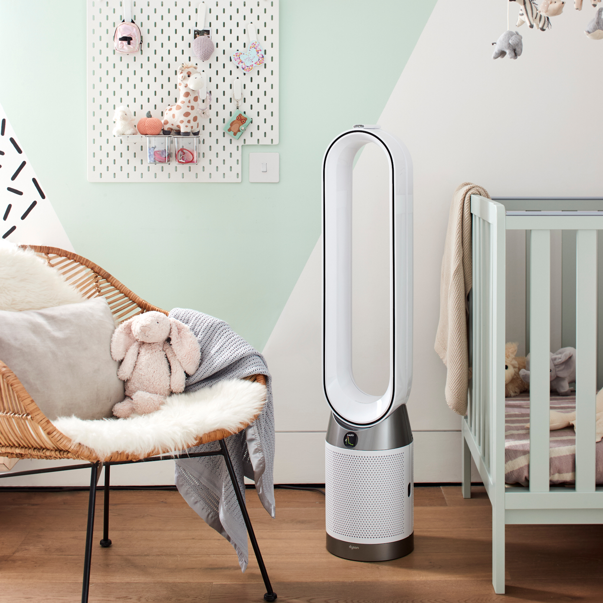 Dyson Purifier Cool in a blue and white nursery room with blue cot, wicker chair and wood flooring