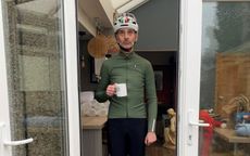 Cycling writer Adam Jones stood in a conservatory door with cycling clothing on