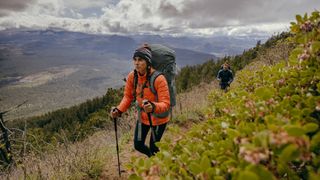 A woman hiking wearing The North Face Thermoball Eco Jacket