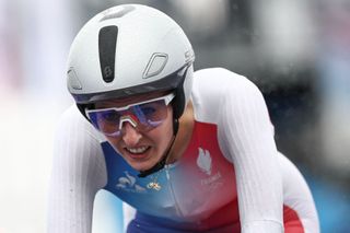 France's Juliette Labous cycles to cross the finish line of the women's road cycling individual time trial during the Paris 2024 Olympic Games in Paris, on July 27, 2024. (Photo by Anne-Christine POUJOULAT / AFP)