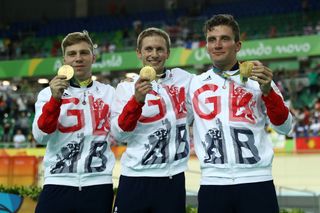 Philip Hindes, Jason Kenny and Callum Skinner of Great Britain celebrate after winning gold and getting an Olympic record in the Men's Team Sprint