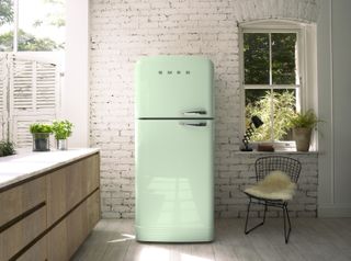 soft green fridge in a white kitchen with a white brick wall