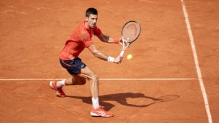 Novak Djokovic plays a backhand at the French Open