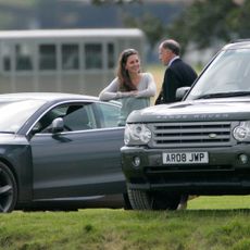 Princess Kate talking to Jamie Lowther-Pinkerton in front of two cars