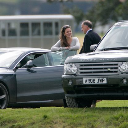 Princess Kate talking to Jamie Lowther-Pinkerton in front of two cars