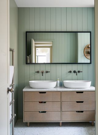 Green bathroom with double wooden vanity