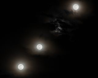 a timelapse photo showing the full moon in three different positions in the sky