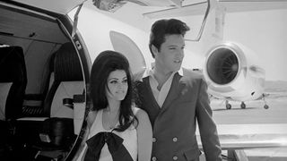 Newlyweds Elvis and Priscilla Presley, who met while Elvis was in the Army, prepare to board their private jet