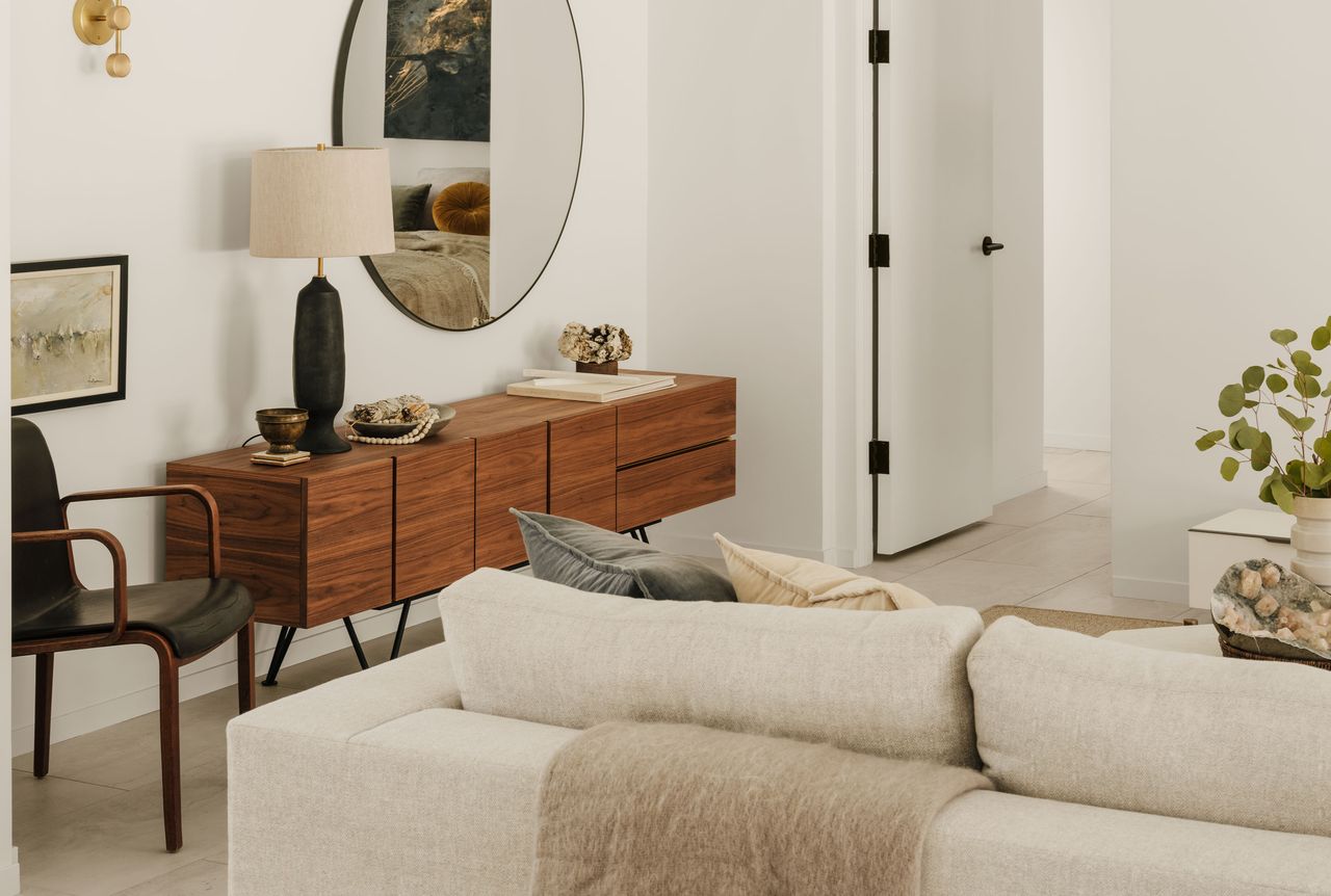 a modern white living room with a sideboard