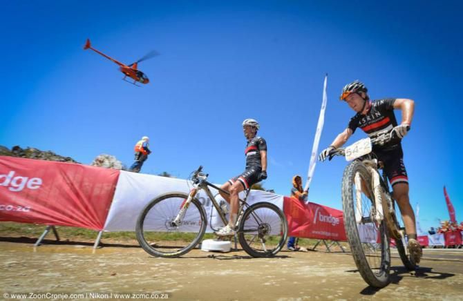 Jens Schuermans (right) and James Reid of Asrin Cycling cross the finish line to win Stage 2