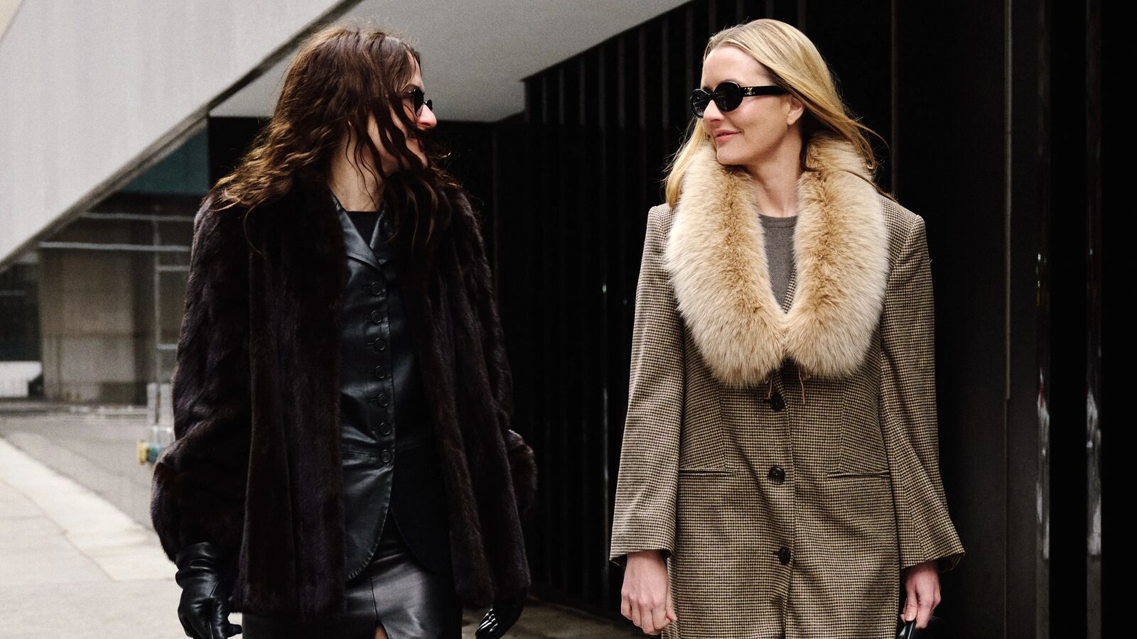 Two women wearing fur-lined coats.