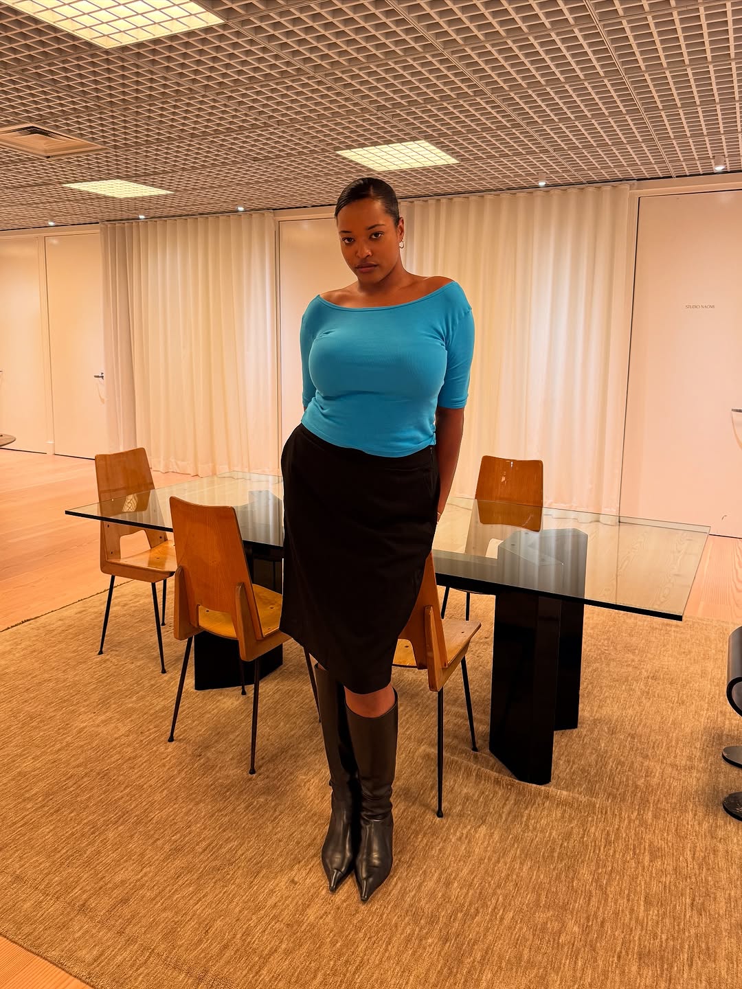 Woman wearing boatneck top.