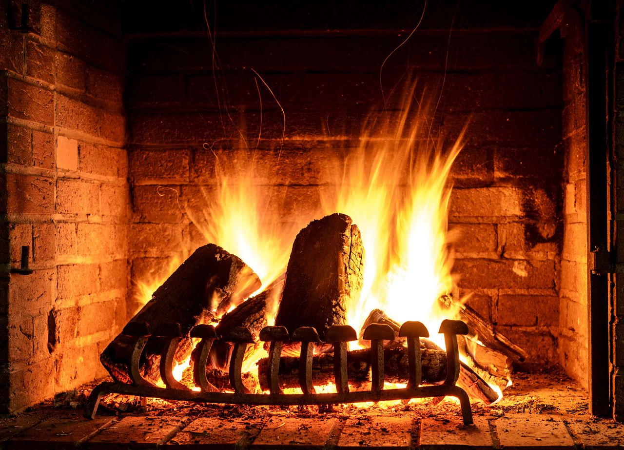 Wood burning in an open fireplace... but that hot air is whooshing up your chimney.