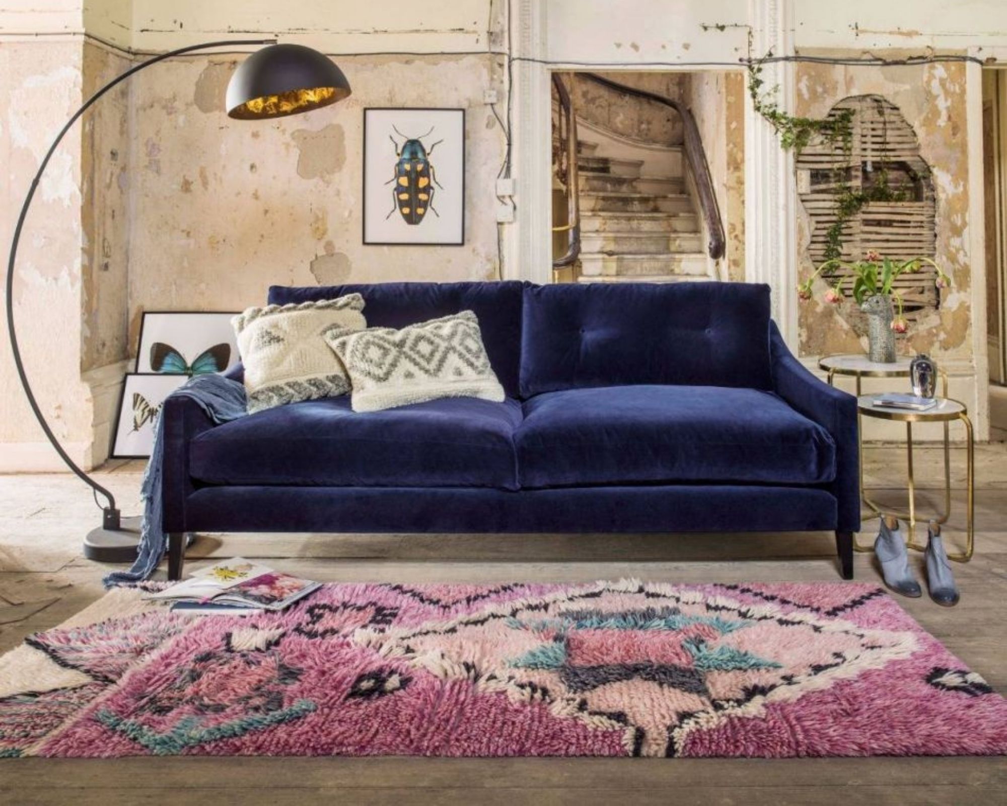 Graham & Green pink Berber style rug in living room with blue velvet sofa, large floor lamp