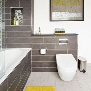 attach bathroom with toilet and grey and white wall