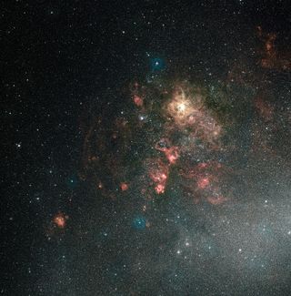 This ground-based view of the Tarantula Nebula shows the nebula in its entirety. It is the brightest region of star formation in the local Universe. Hubble’s field of view covers just a tiny spot in the upper-right quadrant of this image, though it reveals detail invisible here, including a supernova remnant. Image released March 15, 2011.