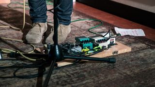 Larger pedalboard at the feet of a guitarist during a gig