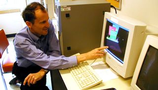 Images from the SETI@home project, including a screenshot of the SETI@home data and a man looking at a large computer with the same screen