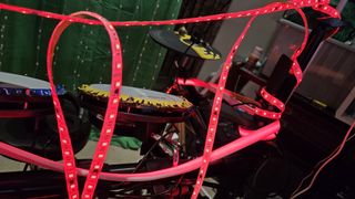 Govee Strip Light Pro 2 light strip set up on a gaming desk and around a drum set.